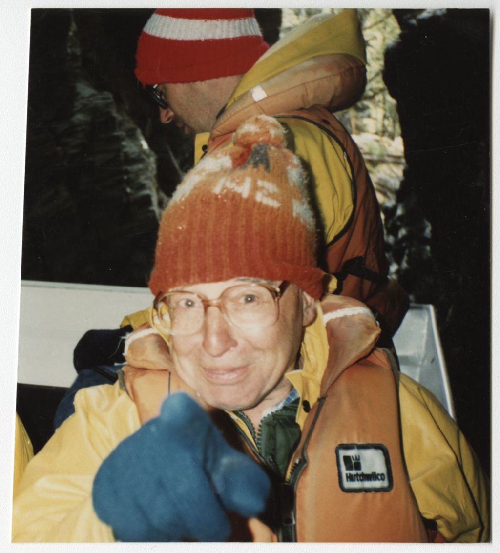 Miniature of Colour photograph of Edwards, pointing at the camera and wearing a lifejacket and woolly hat [in New Zealand]