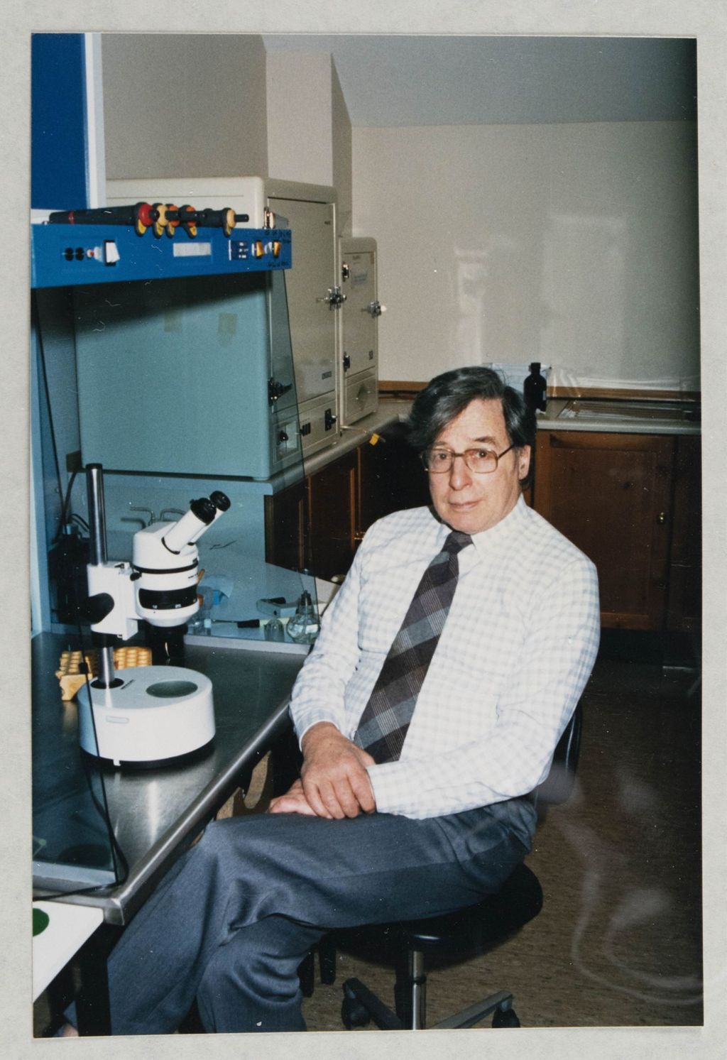 Miniature of Colour photographs of Edwards sitting at a microscope [in Bourn Hall]